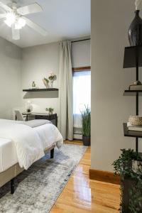 a bedroom with a bed and a desk and a window at Spacious Stay near Yale in Downtown New Haven in New Haven