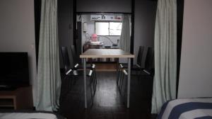 a small dining room with a table and chairs at Apartment Namba Daikoku in Osaka