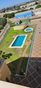 an overhead view of a swimming pool in a park at Apto Lux Sevilla in Seville