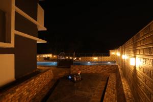 a night view of a building with a bench and lights at Casa Lola in Lonavala