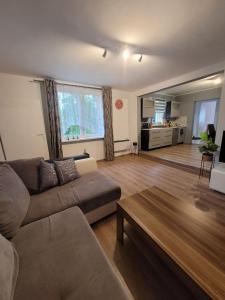 a living room with a couch and a table at Apartament MariaNova 100m2 Zabrze Pawłów in Zabrze