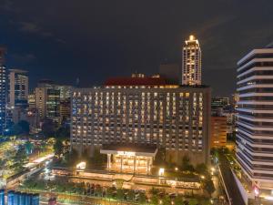 a large building in a city at night at Sari Pacific Jakarta, Autograph Collection in Jakarta