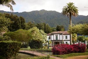 a house with a bridge and a palm tree at Octant Furnas in Furnas +143 photos