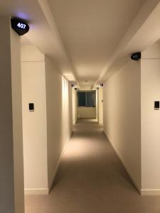 an empty hallway in an office building with a sign on the ceiling at Soho Hotel in Busan