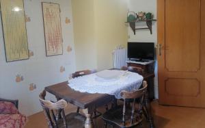 Zimmer mit einem Tisch, Stühlen und einem TV in der Unterkunft B&b Villaggio Sole in Sulmona