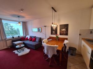 een woonkamer met een tafel en een bank bij Harzblick 13 in Hahnenklee-Bockswiese