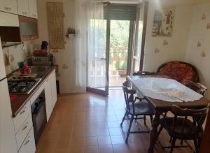 a kitchen with a table and a table and chairs at B&b Villaggio Sole in Sulmona
