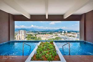 a swimming pool with a view of a city at The Horizon - Ipoh in Ipoh