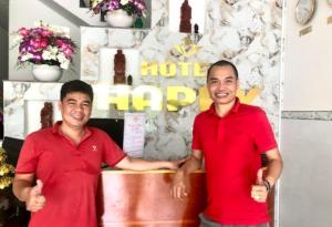 two men in red shirts giving the thumbs up at Happy 1 Hotel Binh Duong in Bến Cát +28 photos