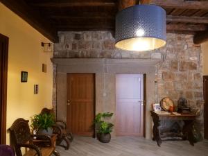 Habitación con pared de piedra, puerta y luz. en Al Cardinale, en Viterbo