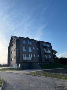 a large black building on the side of a road at Horský Apartmán Černý Důl in Lauterwasser +10 photos