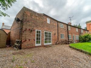 a large brick building with a lot of windows at Pass the Keys Beautiful 5 Guest Cottage near City Centre in Nottingham