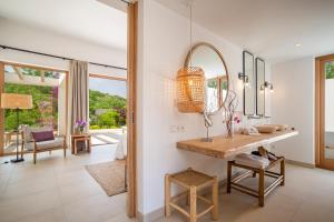 a bathroom with a sink and a mirror at Can Lluc Hotel Rural in Sant Rafael de Sa Creu