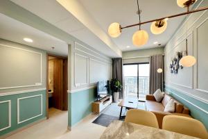 a living room with a couch and a table at Yu Stay Apartment in Soho D1 near Bui Vien walking street in Ho Chi Minh City