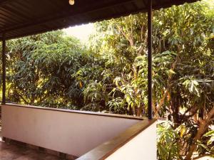 a screened in porch with trees in the background at Villa Sun Ray in Tissamaharama