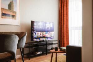 a living room with a flat screen tv in a room at Apartamenty Blue in Biała Podlaska