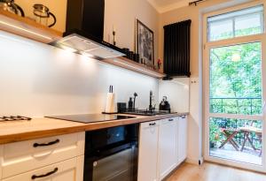 a kitchen with a stove top oven next to a window at U Siemienia in Krakow