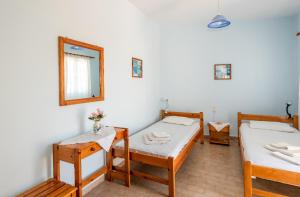 a room with two beds and a mirror at Giannis apartment in Kalymnos