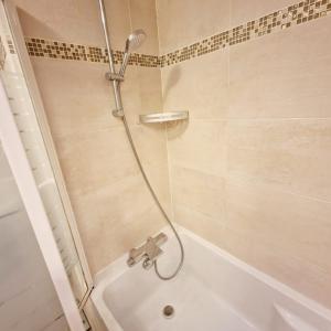 a bathroom with a shower with a bath tub at Modern and confortable apartment close to Paris in Bois-Colombes