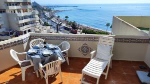 d'un balcon avec une table et des chaises donnant sur l'océan. dans l'établissement BENALBEACH SEA VIEW 2BDR Apartment with Water Park, à Benalmádena