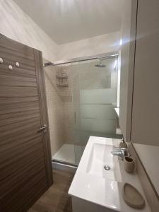 a bathroom with a sink and a shower at RED SKY APARTMENT - PORTA DI ROMA in Rome