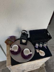 a table with a hat and a tea set on it at Deni in Sevid