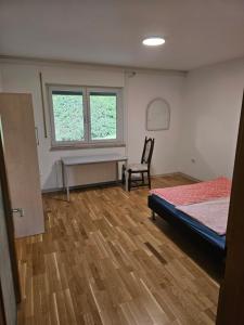 a room with a bed and a chair in it at ⌂ Privatwohnung in Burghaun