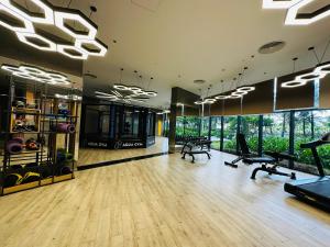 a gym with treadmills and ellipticals in a building at The Arena Cam Ranh Beach Front in Cam Ranh