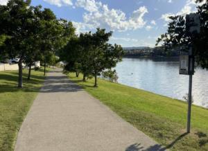 a sidewalk next to a body of water with trees at Self contained guest house - sleeps 4 in Gold Coast