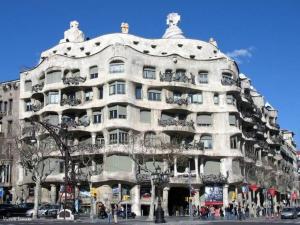 a large white building with people standing outside of it at New flat in the center-Eixample Passeig de Gracia in Barcelona