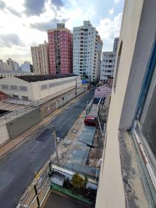 a view from a window of a city street with buildings at Canto do Bosque Home office in Campinas