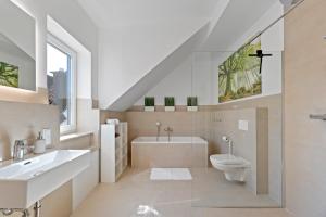 a bathroom with a sink toilet and a tub at Golden Home with Barbecue, Yoga, Football Table in Sinsheim +20 photos