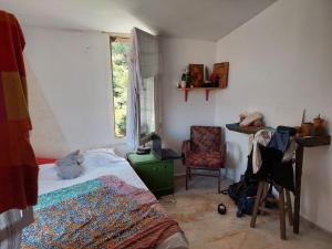 a bedroom with a bed and a chair and a window at Zima Art Studio in Marmaris