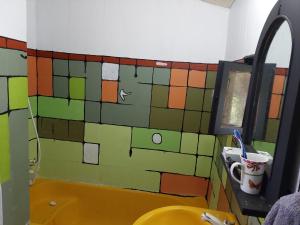 a bathroom with a tiled wall next to a sink at Zima Art Studio in Marmaris