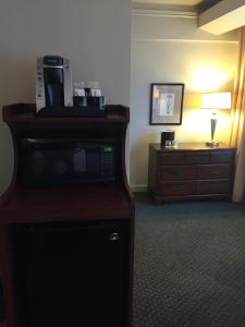 a hotel room with a microwave and a dresser at The Inn at Virginia Mason in Seattle