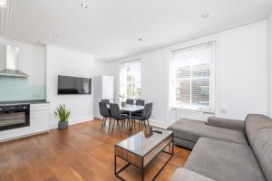 a living room with a couch and a table at Spacious Apartments London Eye, Westminster, Big Ben, Borough Market in London