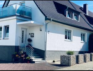 a white house with a balcony on top of it at Ferienwohnung mit Balkon in Calden in Calden