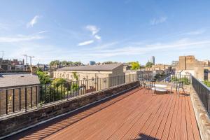 a balcony with chairs and a view of a city at Luxury Apartments London Eye, Westminster, Big Ben, Borough Market in London