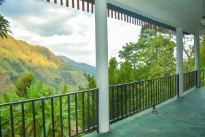 a balcony with a view of the mountains at Nature Green Hotels On Rock Home Ella in Ella +80 photos