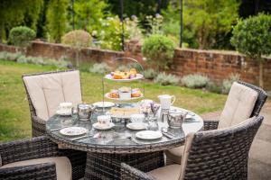 a table with a tray of food on it at Bromley Court Hotel London in Bromley