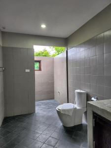 a bathroom with a toilet and a shower with a window at Hua Hin Home Hill in Hua Hin