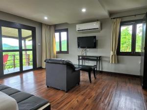 a living room with a couch and a television at Hua Hin Home Hill in Hua Hin