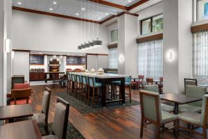 a dining room with a table and chairs at Hampton Inn & Suites at Lake Mary Colonial Townpark in Lake Mary