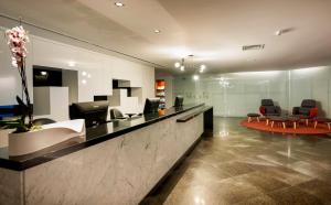 an office lobby with a reception desk and chairs at Hotel Senac Ilha do Boi in Vitória