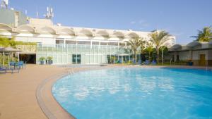 a large swimming pool in front of a building at Hotel Senac Ilha do Boi in Vitória