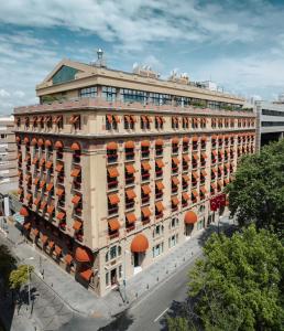 a large building with orange balconies on a city street at Park Hyatt Istanbul - Macka Palas in Istanbul