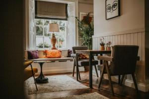 a living room with a table and chairs and a window at The Croft Hotel in Darlington +22 photos