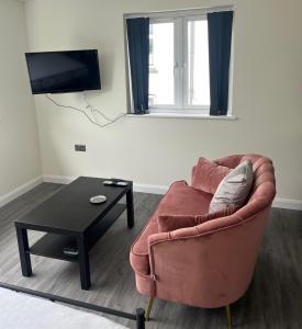 a living room with a couch and a coffee table at Studio apartment in Harefield in Harefield