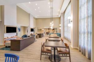 a waiting room at a hospital with tables and chairs at Sonesta ES Suites Andover Boston in Andover