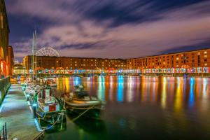 a group of boats docked in a harbor at night at Seymour Townhouse by Serviced Living Liverpool in Liverpool